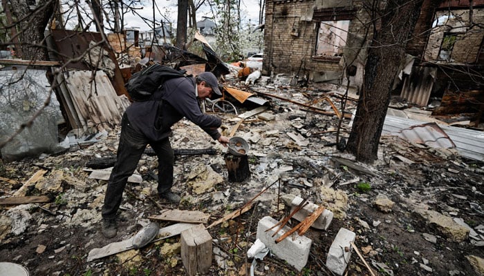 Oleksiy Sokolyuk, 50, shows how he was cooking by his house, that according to him was destroyed by shelling, the first on March 5, and the second on March 17, amid Russian invasion of Ukraine, in Irpin, outside Kyiv, Ukraine May 4, 2022. — Reuters