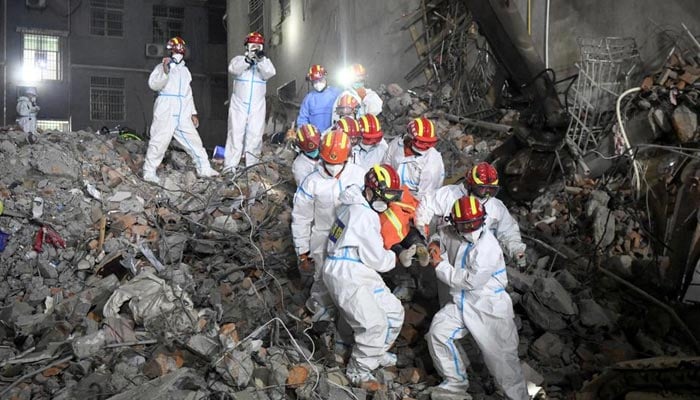 Rescue workers carry a survivor on a stretcher more than 131 hours after a building collapsed in Changsha, Hunan province in China. — Reuters/File