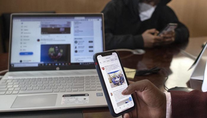 The picture shows a person using social media on a phone. — AFP/File