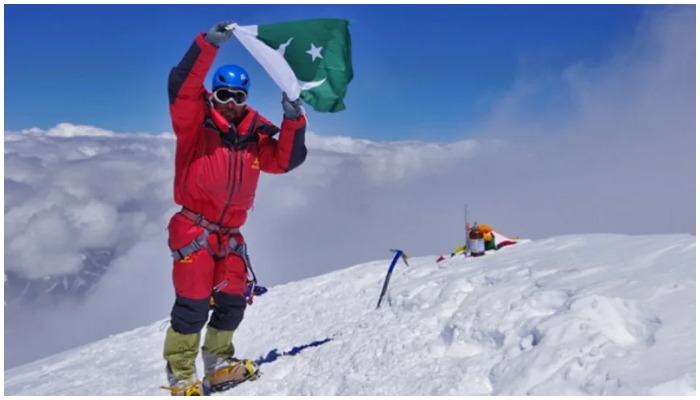 Pakistan’s ace mountaineer Sirbaz Ali Khan raises the Pakistani flag after scaling8,586-metre Kanchenjunga. — Alpine Club