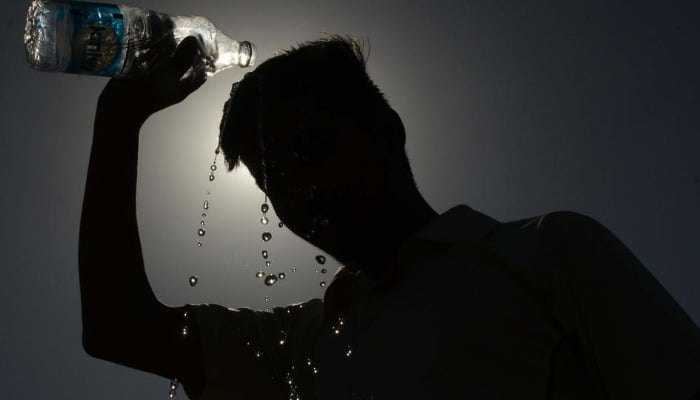 The picture shows a boy pouring water on his head. — AFP/File
