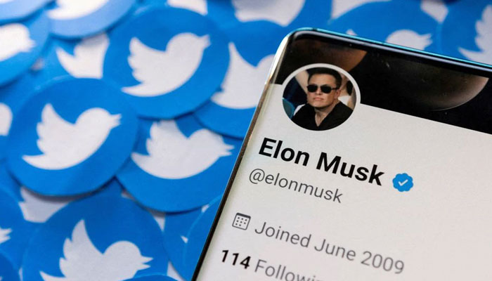 Elon Musks Twitter profile is seen on a smartphone placed on printed Twitter logos in this picture illustration taken April 28, 2022. — Reuters/File