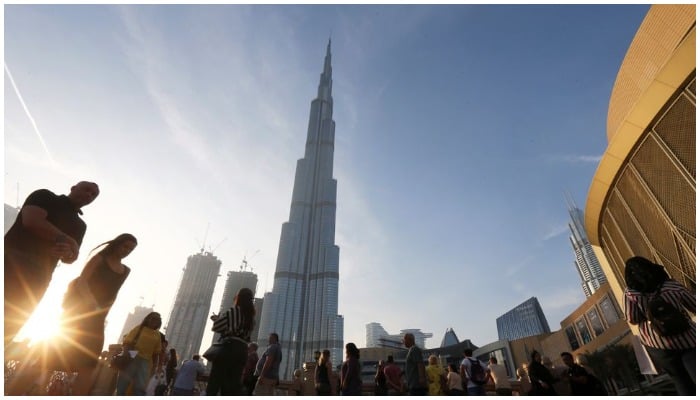 People are seen in front of Burj Khalifa, the world tallest building, in Dubai, United Arab Emirates March 12, 2020. — Reuters
