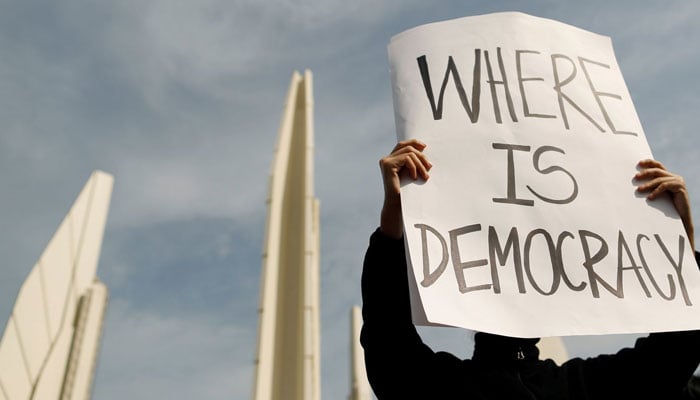 A pro-democracy protester holds a sign at a rally to demand the government to resign, to dissolve the parliament and to hold new elections under a revised constitution, near the Democracy Monument in Bangkok, Thailand, August 16, 2020. — Reuters/File