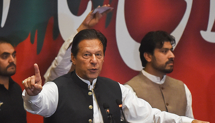 Former prime minister Imran Khan, who was ousted by opposition parties through a no-confidence motion, gestures as he addresses Pakistan Tehreek-e-Insaf (PTI) party workers during a party convention in Lahore on April 27, 2022. — AFP