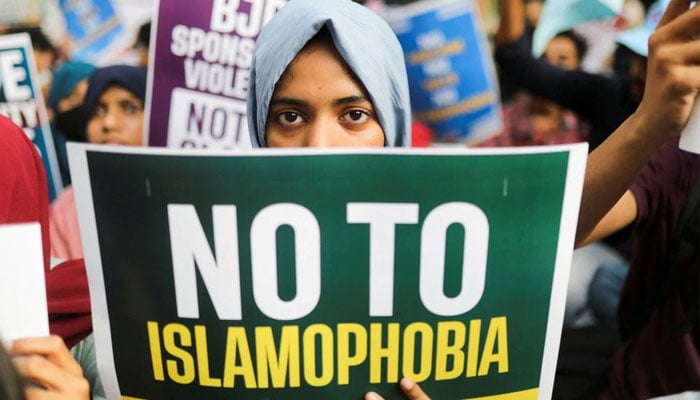 A citizen holds a placard during a peace vigil organised by citizens against what they say is a rise in hate crimes and violence against Muslims in the country, in New Delhi, India, April 16, 2022. — Reuters/File