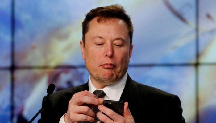 Elon Musk looks at his mobile phone in Cape Canaveral, Florida, US, on January 19, 2020.— Reuters