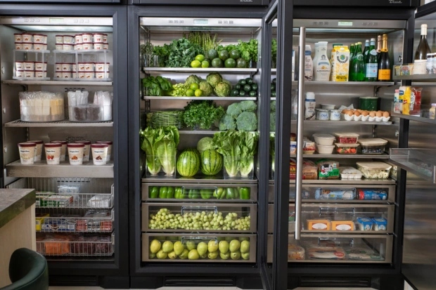 Her all-black fridge in neatly organized and one section is all green