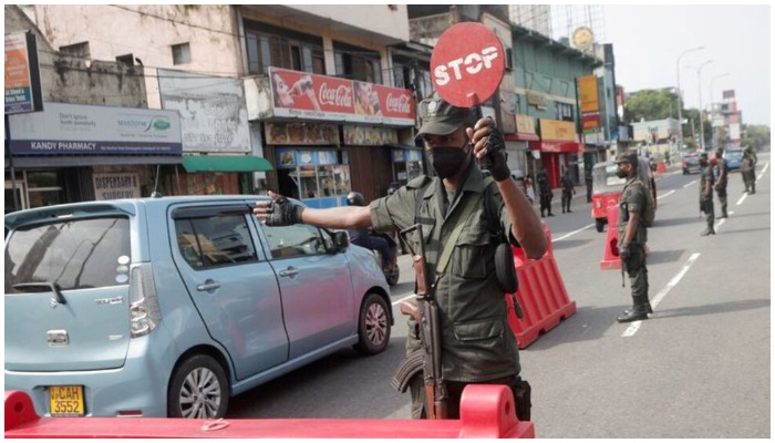 An army member stops vehicles at a checkpoint on the main road after the curfew was extended for another extra day following a clash between Anti-government demonstrators and Sri Lankas ruling party supporters, amid the countrys economic crisis, in Colombo, Sri Lanka, May 11, 2022. — Reuters