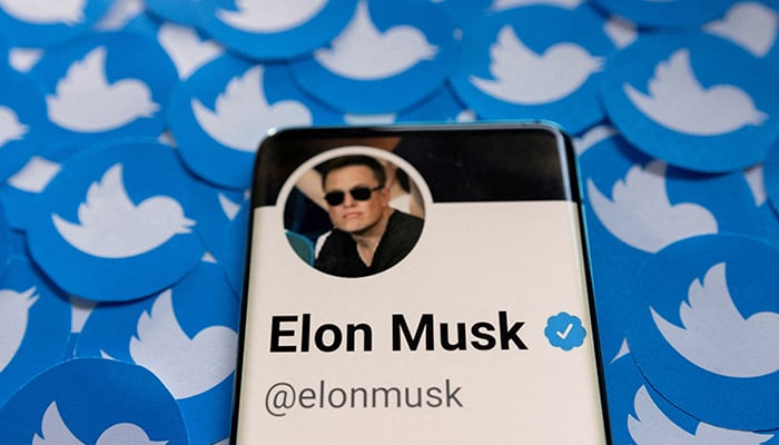 Elon Musks Twitter profile is seen on a smartphone placed on printed Twitter logos in this picture illustration taken, on April 28, 2022. — Reuters