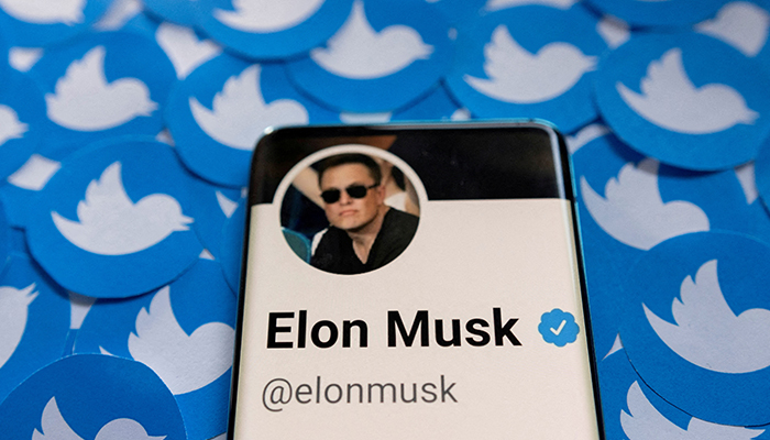 Elon Musks Twitter profile is seen on a smartphone placed on printed Twitter logos in this picture illustration taken, on April 28, 2022. — Reuters