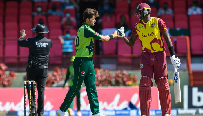 Shaheen Shah Afridi (left) bumps fists with a West Indian player. — ICC