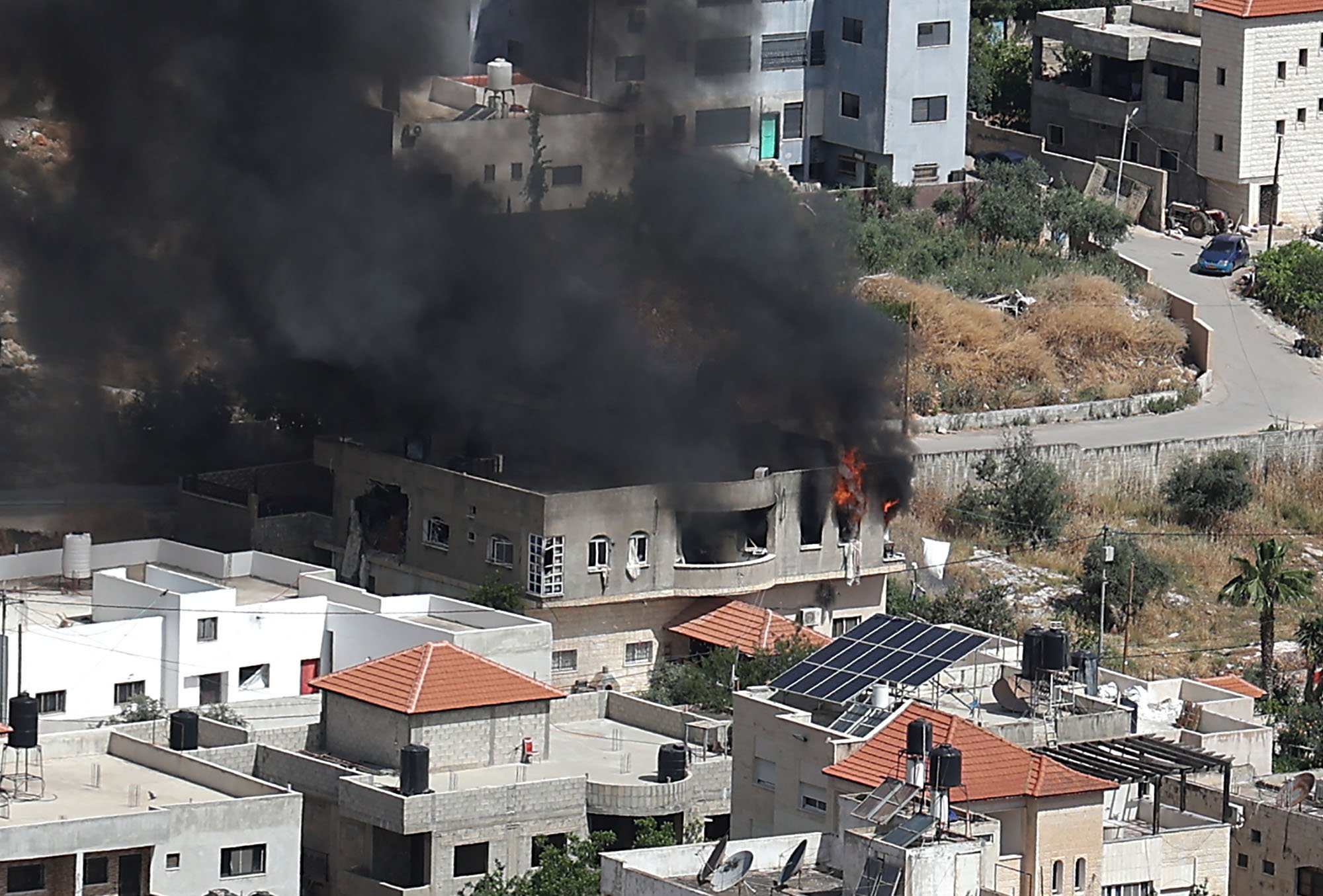 Smoke billows from a building in the Jenin refugee camp on May 13, 2022, during an Israeli military raid. Israel was bolstering security forces in Jerusalem ahead of veteran Al Jazeera journalist Shireen Abu Aklehs funeral, two days after she was killed during an Israeli army raid. — AFP