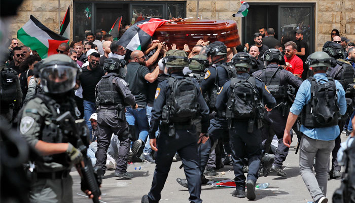Israeli security attacks mourners from carrying the casket of slain Al-Jazeera journalist Shireen Abu Akle out of a hospital, before being transported to a church and then her resting place, in Jerusalem, on May 13, 2022. — AFP