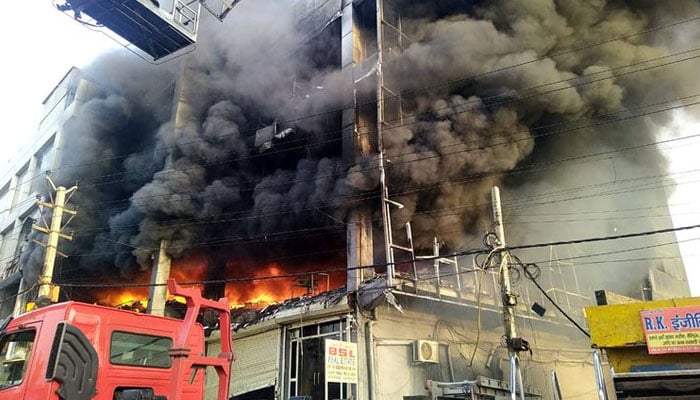 Flames and Smoke billow after a fire broke out in a building near Mundka metro station, in New Delhi on Friday, May 13, 2022. Photo— Gulf News