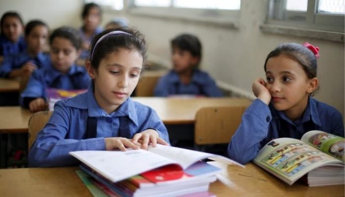 Refugee schoolchildren receive their new books on the first day of the new school year at one of the UNRWA schools at a Palestinian refugee camp al Wehdat, in Amman, Jordan, September 1, 2016.—Reuters