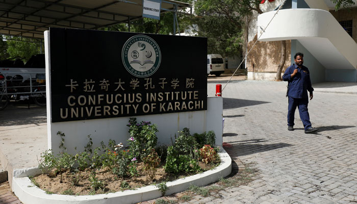 A security guard walks at the entrance of the Confucius Institute University of Karachi. — Reuters/File