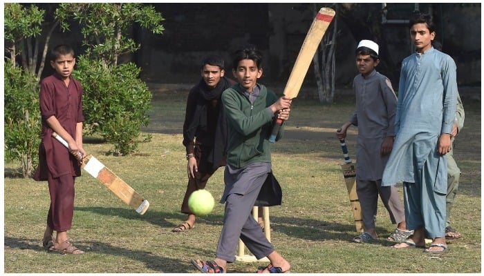 Children play cricket at a playground in Lahore, Pakistan, Nov. 19, 2020. — AFP/File