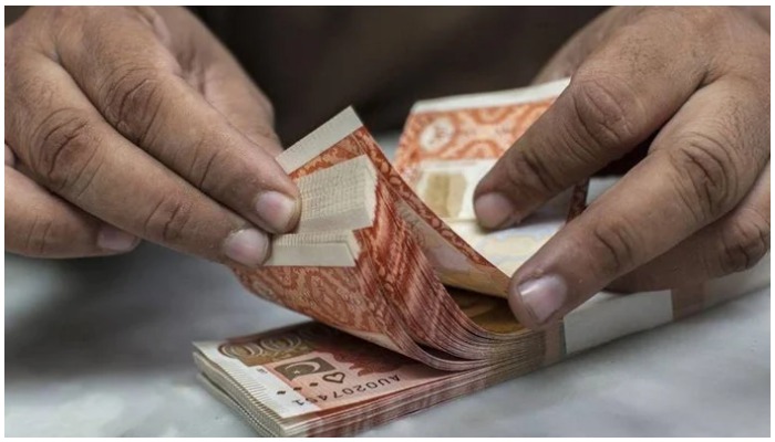 Person counting Rs5,000-rupee notes from a stack. — AFP/File