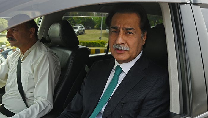 Minister for Economic Affairs Ayaz Sadiq Sardar Ayaz Sadiq (right) arrives at the parliament house building in Islamabad on April 11, 2022. — AFP