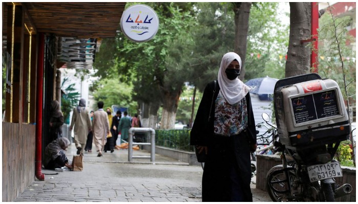 An Afghan woman walks on a street in Kabul, Afghanistan, May 9, 2022. Reuters