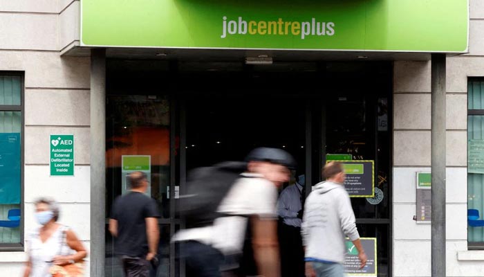 People walk past a branch of Jobcentre Plus, a government-run employment support and benefits agency, in Hackney, London, Britain, on August 6, 2020. — Reuters