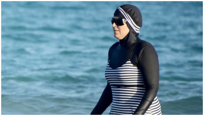 A woman at the beach wearing a burkini. — AFP