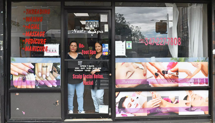 Deepa Shrish Singgali (R) and Maya Bhusal Basnet (L) at Deepa’s work place the Mt. Everest Nail Salon in Ridgewood, Queens, New York, May 11, 2022. Photo: AFP