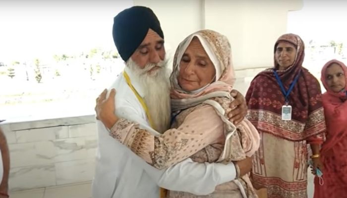 Mumtaz Bibi hugs one of her brothers after reuniting with her family at Kartarpur in Punjab. —Dawn News