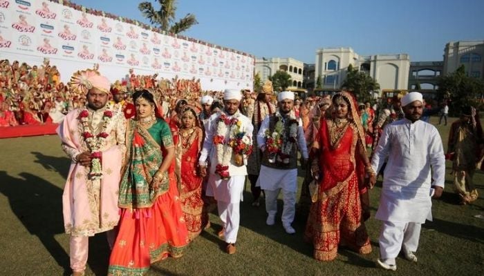 Brides and grooms arrive to take their wedding vows during a mass marriage ceremony, organized by a diamond merchant, in which 261 including six Muslim and three Christian couples took their wedding vows, in Surat, Gujarat December 23, 2018 — Reuters
