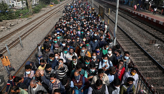 Commuters leave a platform after disembarking from a suburban train, amidst the spread of the coronavirus disease (COVID-19), at a railway station on the outskirts of Kolkata, India, January 5, 2022. — Reuters