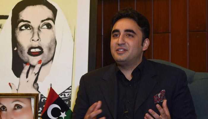 Foreign Minister Bilawal Bhutto-Zardari speaking to journalists, while a portrait of his deceased mother, Benazir Bhutto, could be seen in the background. — AFP/File