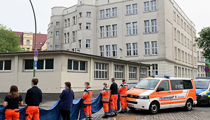 Emergency medical workers stand near a German school building where shots were fired, in the northern city of Bremerhaven, Germany, on May 19, 2022. — Reuters