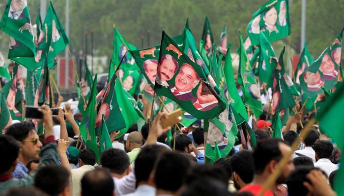 PML-N supporters wave party flags to welcome party supremo Nawaz Sharif during a rally on GT Road following his ouster by the Supreme Court of Pakistan in July 2017. — Reuters/File