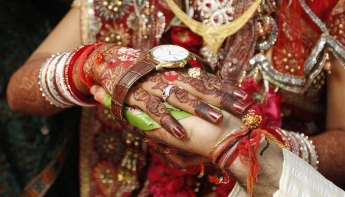 Bride Kalpana, 22, and her groom Bhavin Munjpara, 26, lying in a bed, exchange wedding vows inside a hospital in Ahmedabad February 17, 2012. The couple took their wedding vows in a hospital after Munjpara fractured his feet in a road accident on February 11, their relatives said. —Reuters