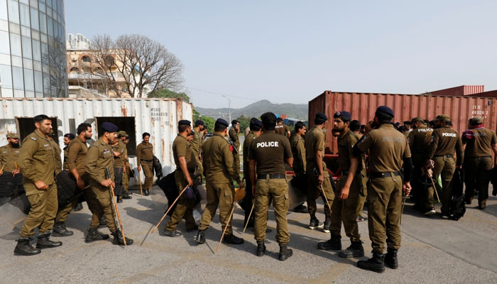 Police officers guard a street where shipping containers have been used to block the road leading towards the Red Zone and parliament building, in Islamabad, Pakistan April 3, 2022. — Reuters/File