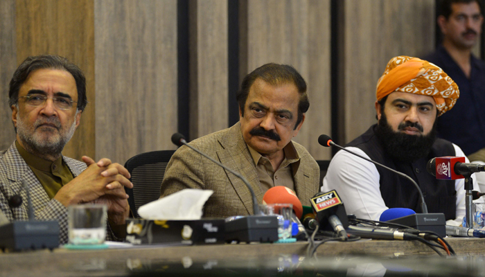 Pakistan Interior Minister Rana Sanaullah (C) along with ruling collation parties leaders Qamar Zaman Kaira (L) and Asad Mehmood (R) listen to a question during a press conference in Islamabad on May 24, 2022. — AFP/File