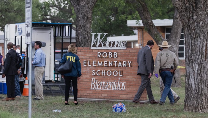 Law enforcement work the scene after a mass shooting at Robb Elementary School. Photo— Jordan Vonderhaar/Getty Images/AFP