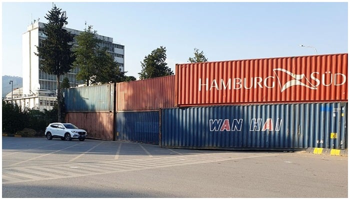 Shipping containers used to block the area leading towards the Red Zone are seen ahead of the planned protest march by ousted Prime Minister Imran Khan, in Islamabad, on Tuesday. — Reuters