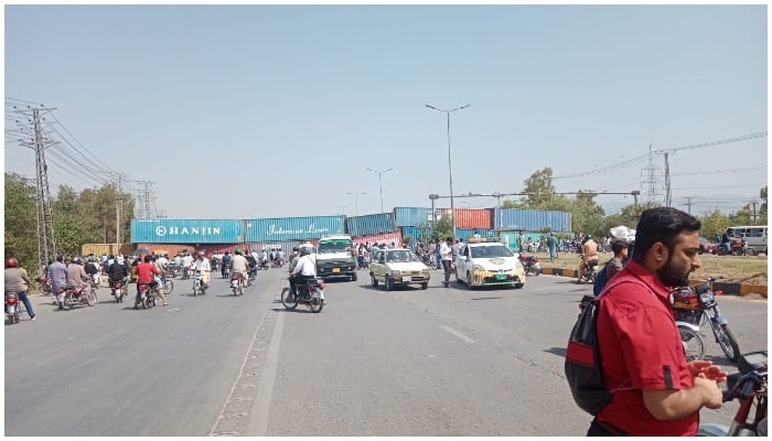 Heavy containers placed to barricade a road to stop PTI marchers. — Twitter