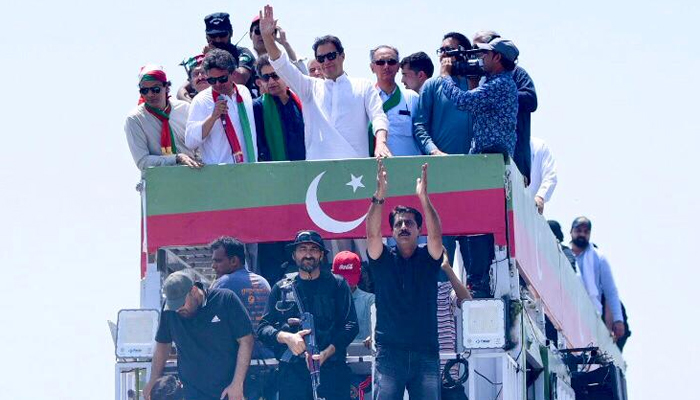 PTI Chairman Imran Khan leads the rally toward Islamabad on a container with other senior leaders of the party. — Twitter/@PTIofficial