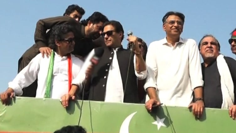 PTI Chairman Imran Khan addressing jalsa along with party members. — Screengrab/Twitter