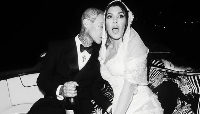 Kourtney Kardashian, Travis Barker share NEW cheeky photos from wedding