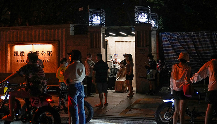 Residents get a haircut on a street during lockdown, amid the coronavirus disease (COVID-19) outbreak, in Shanghai, China, May 27, 2022. — Reuters