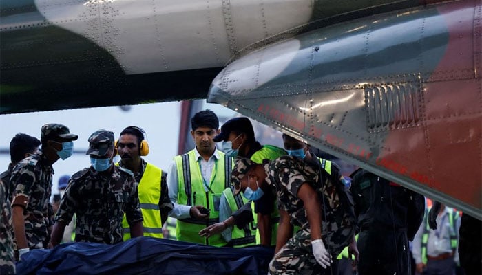 Member of Nepal Army carries the body of a victim of the Tara Air passenger plane, that crashed with 22 people on board while on its way to Jomsom, from the helicopter at the airport in Kathmandu, Nepal May 30, 2022. — Reuters