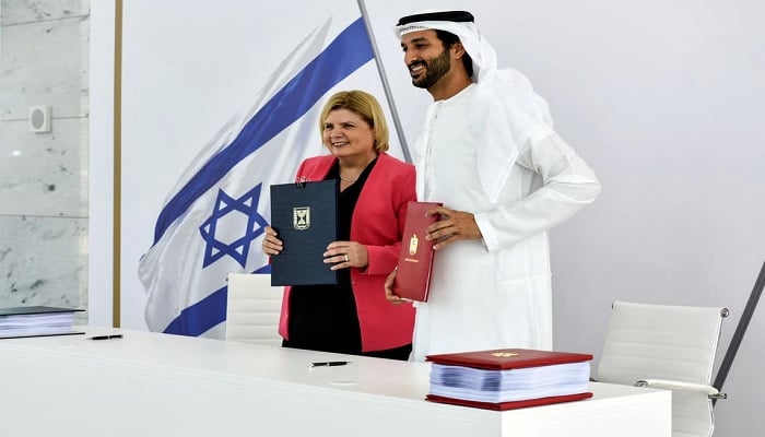 Israels Minister of Economy and Industry Orna Barbivai and UAE Minister of Economy Abdulla bin Touq Al Marri present the Free Trade Agreement they signed, which is the first such agreement Israel has with an Arab county, in Dubai, United Arab Emirates May 31, 2022.—Reuters