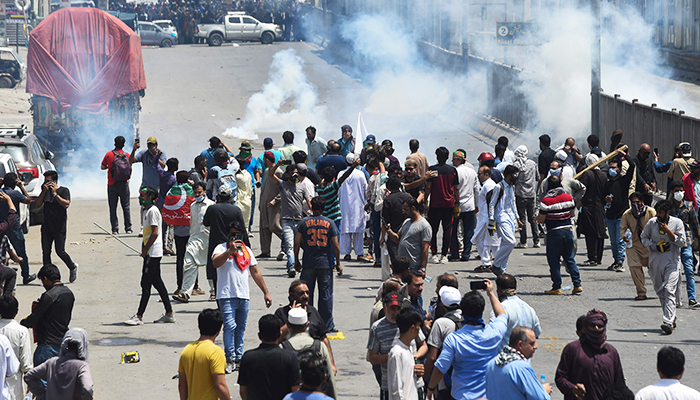 Police use tear gas to disperse activists of the PTI, the party of ousted prime minister Imran Khan, during a protest in Lahore on May 25, 2022. — AFP