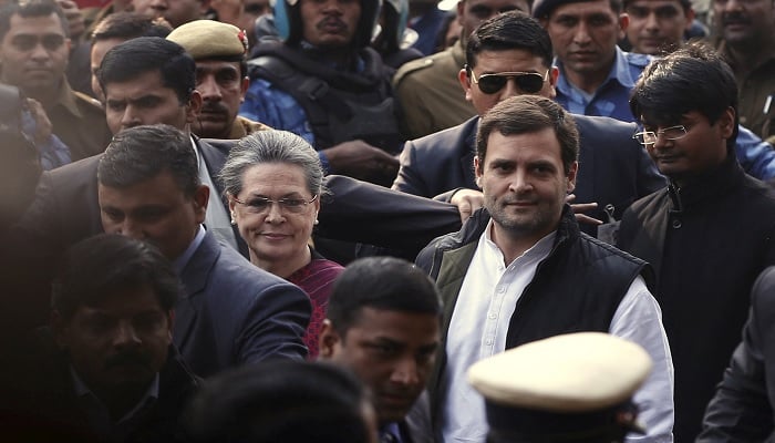 Indias main opposition Congress party president Sonia Gandhi and her son and party vice-president Rahul Gandhi (2nd R) arrive at a court in New Delhi, India, December 19, 2015.—Reuters
