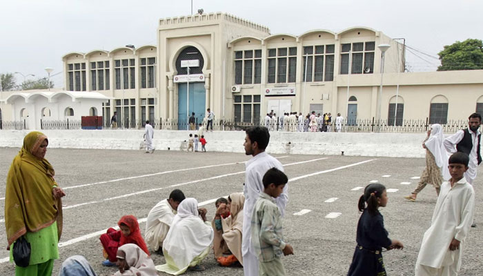 Visitors who come to see their jailed loved ones wait in the premises of Adiala Jail in Rawalpindi. — AFP/File