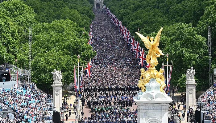 Members of the public fill The Mall ahead of a fly-past over Buckingham Palace, during the Queens Birthday Parade. — AFP